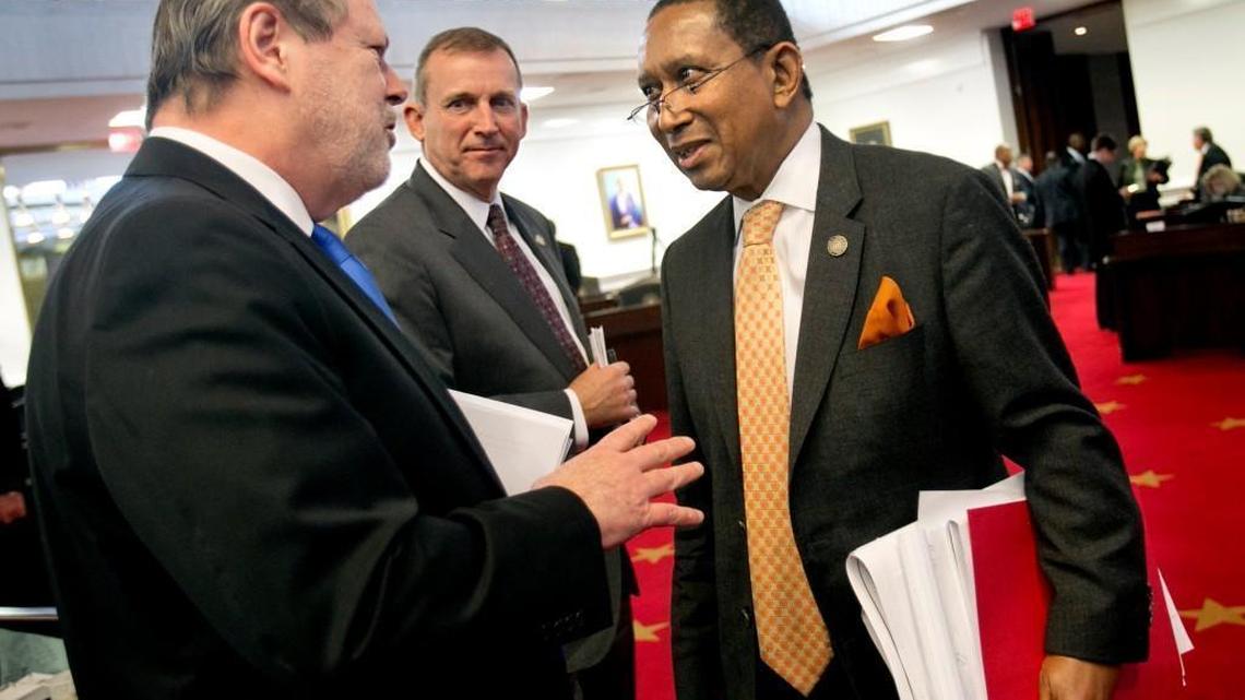 Republican Senators President Pro Tempore Phil Berger, left, and Majority Leader Harry Brown, center, congratulate Floyd McKissick, Jr. (Dem), right, on a good debate after the Senate approved a new redistricting map on Tuesday, February 16, 2016 at the N.C. General Assembly. The Republicans approved the map with a vote of 32-15.