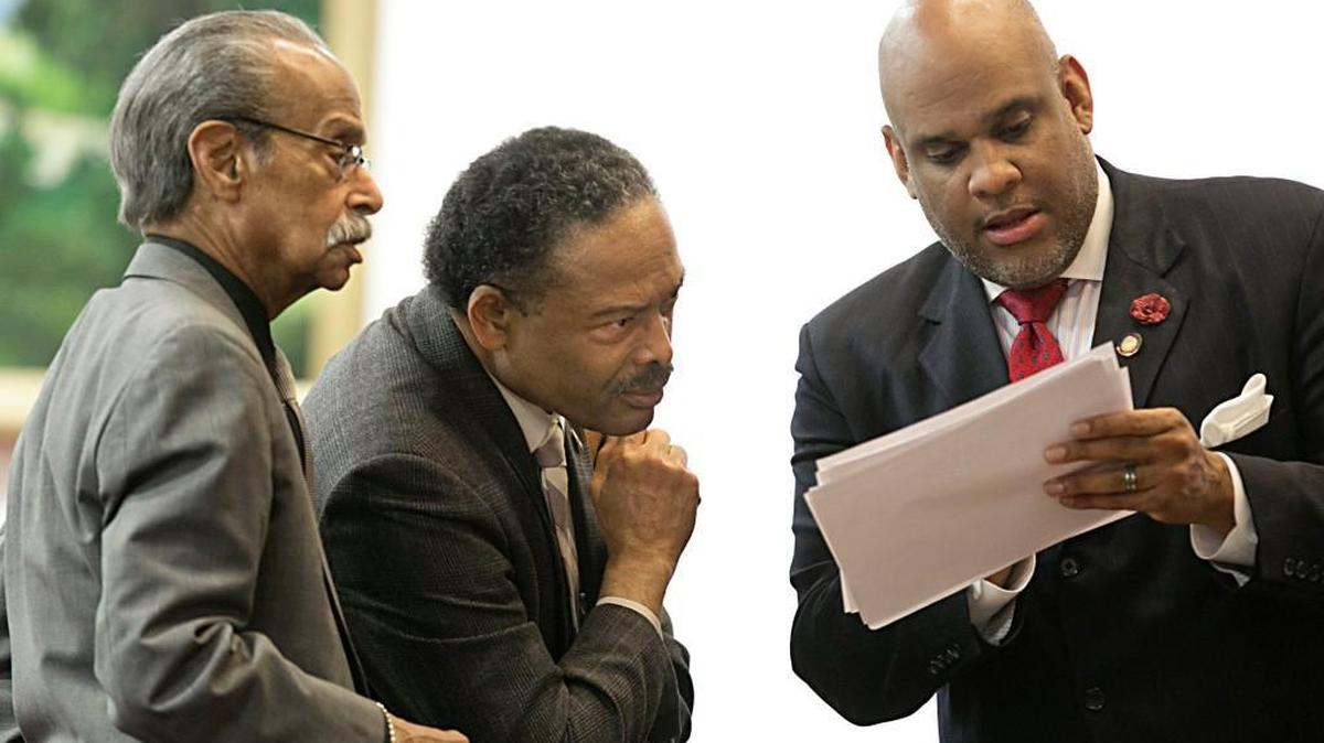 Henry “Mickey” Michaux, Jr., left, Kelly Alexander, Jr., center, and Ed Hanes Jr., right, huddle before the start of a debate in the N.C. House of Representatives in February 2016.