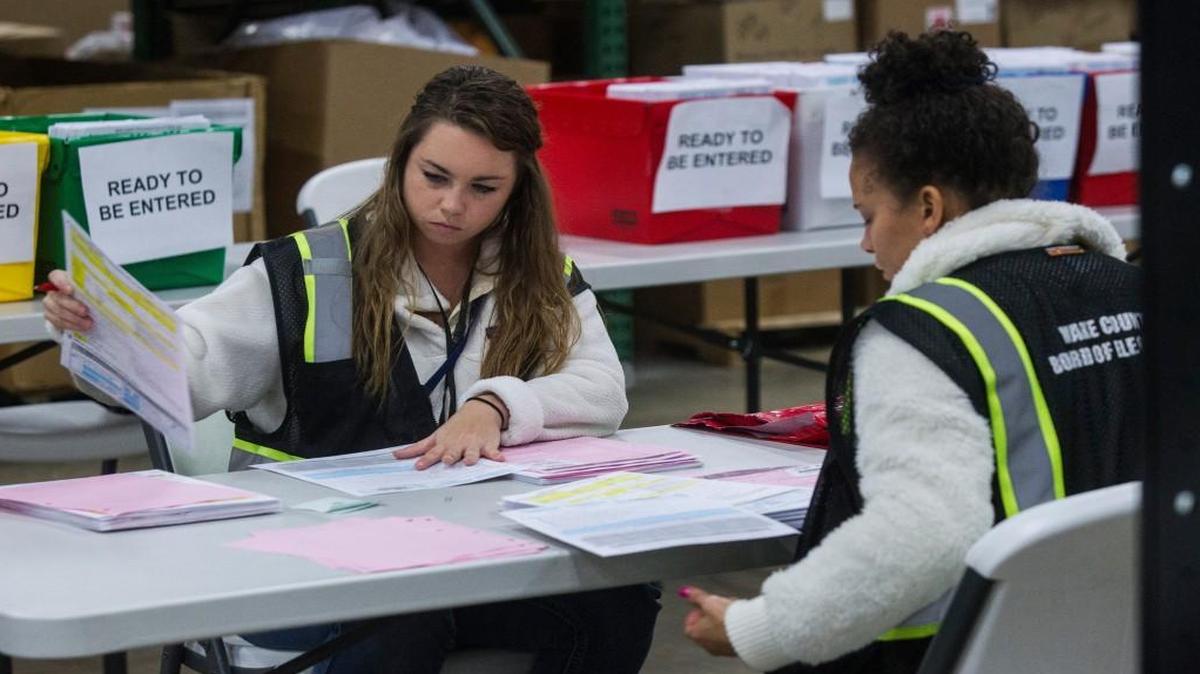 Wake County Board of Elections staff Ragan Taylor, left, and Ashley Stoddard audit provisional ballots Thursday at the Wake County Board of Elections warehouse in Raleigh.