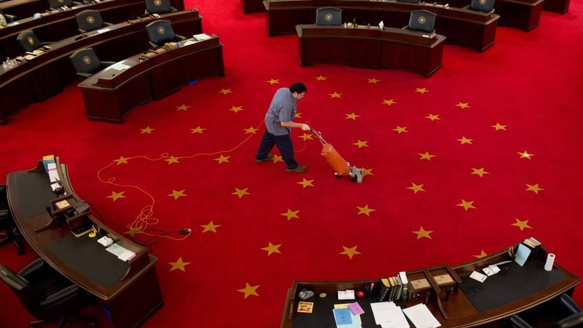 Jose Ochoa vacuums the in the North Carolina Senate Chamber Thursday, April 21, 2016 in Raleigh, N.C.