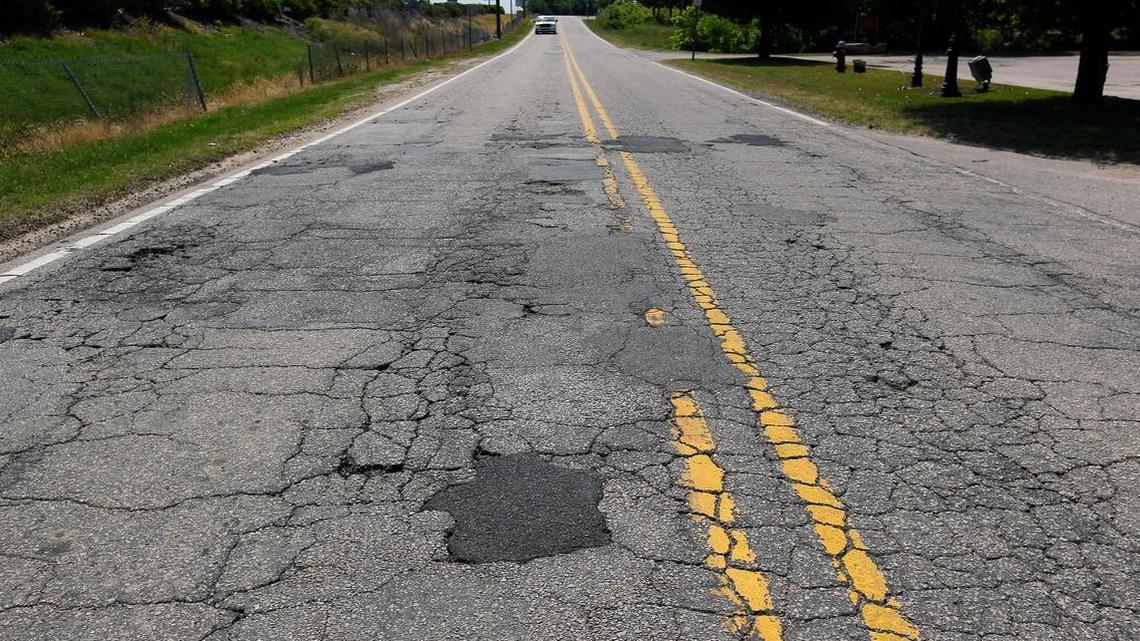
Vehicles maneuver through patches, cracks and potholes on Yonkers Road in Raleigh. Rep. John Torbett backed away from a plan to raise funds for repaving roads throughout the state in part by adding a new 6.5 percent tax to the annual price of automobile insurance.
