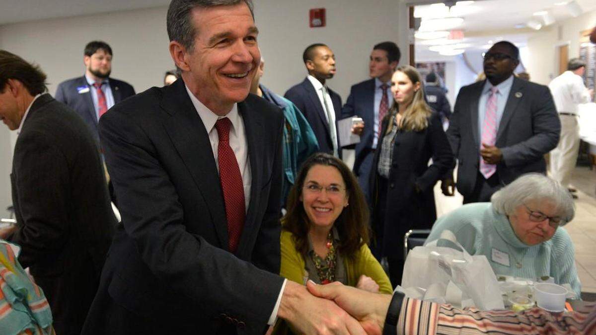 North Carolina Attorney General Roy Cooper greets fellow Democrats before speaking to the Uptown Democratic Forum, Friday, Feb. 5, 2016. Cooper is running for governor.