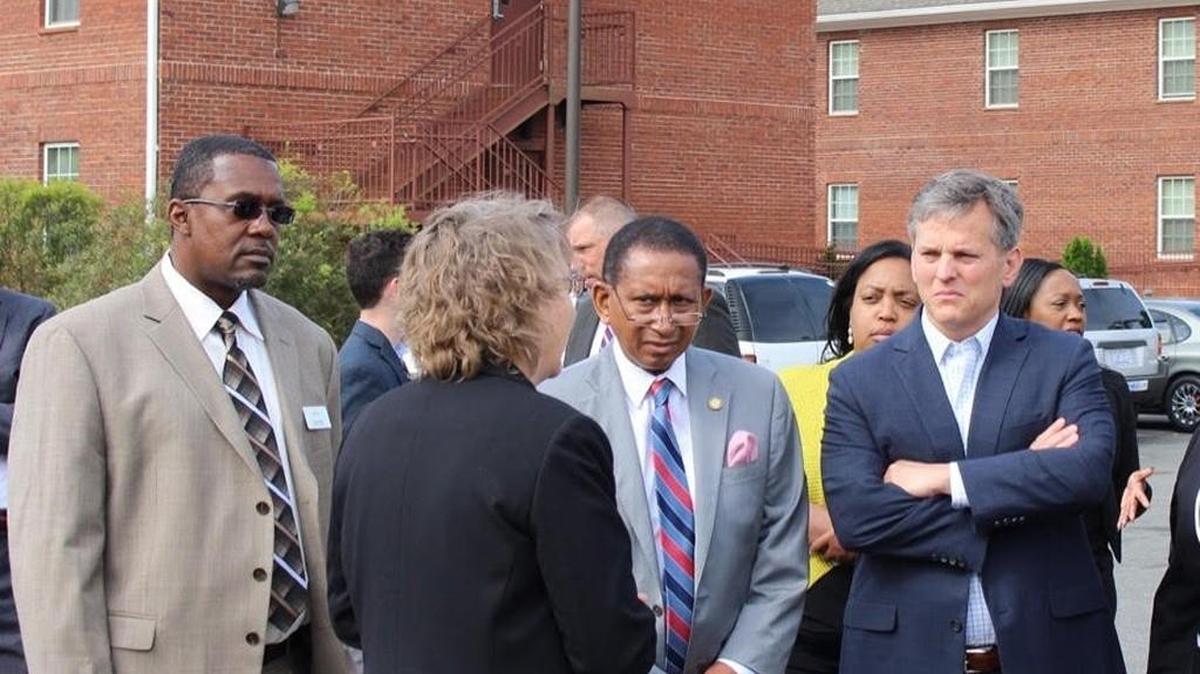 NC Attorney General Josh Stein, pictured at the right in Durham earlier this year, is trying to figure out how to fend off mass layoffs in his office.