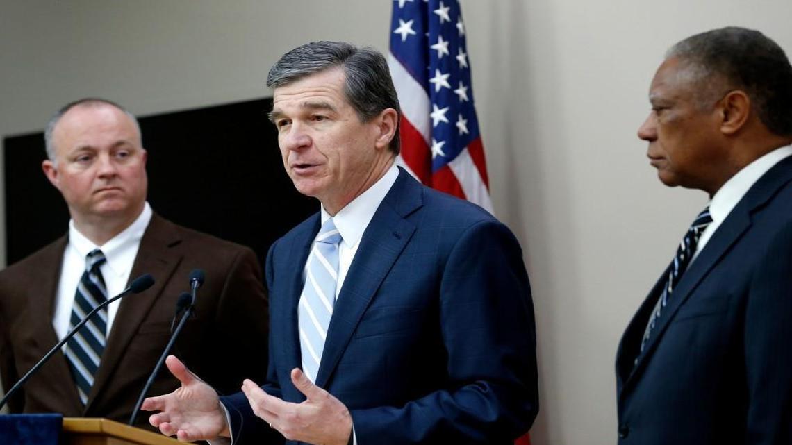 N.C. Gov. Roy Cooper, center, holds a press conference with N.C. House Democratic leader Darren Jackson, left, and N.C. Senate Democratic leader Dan Blue in February.