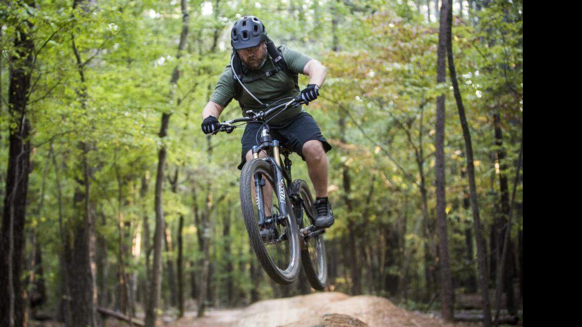 
Shawn Troy of Cleveland rides the popular mountain bike trails on RDU Airport Authority'e FATS tract leased by the Lake Crabtree County Park Wednesday, October 8, 2014. Wake County has leased the land from the airport authority that gives visitors to Lake Crabtree County Park extra acreage on which to hike, geocache and mountain bike. But last year, the airport authority wouldn't renew the lease, saying it wanted to consider development options for the property. 
