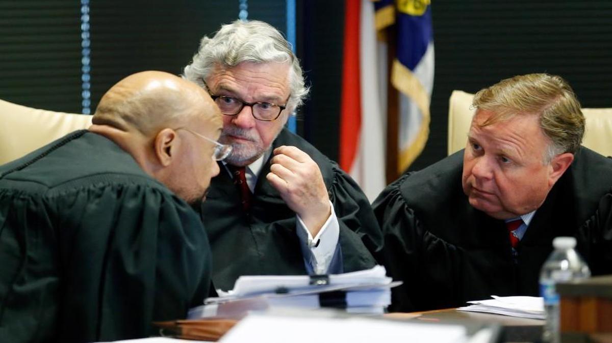 A three judge panel of, from left, L. Todd Burke, Jesse B. Caldwell and Jeffery B. Foster confer in a case where Gov. Roy Cooper is challenging the General Assembly's authority to oversee some state agency's powers and appointments during a hearing held at a Campbell Law School courtroom in Raleigh, NC on Tuesday.