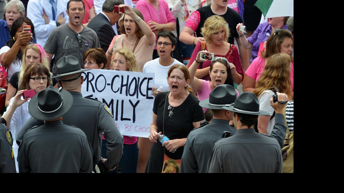 
A crowd shouts "shame shame shame" as law enforcement officers stand outside the Legislative building in Raleigh in a 2013 pro-choice rally. On Monday, June 15, 2015, the U.S. Supreme Court said it will not review a ruling that struck down North Carolina’s 2011 abortion ultrasound law, effectively preventing the law from being enacted.
