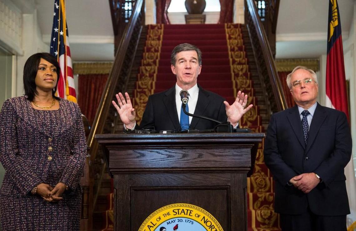 Gov. Roy Cooper, center, announces the selection Machelle Sanders, left, to lead the Department of Administration and Tony Copeland to lead the Department of Commerce Thursday, January 12, 2017 during a press conference at the Executive Mansion.