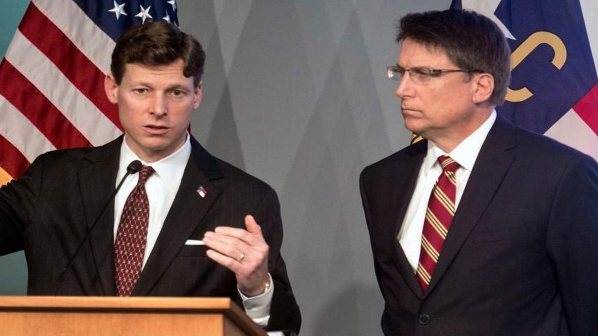 State Budget Director Lee Roberts, left, addresses members of the media, as N.C. Governor Pat McCrory listens in the Joint Force Headquarters Media Briefing Room in Raleigh, N.C. on Thursday, March 5, 2015. They unveiled the governor's proposed 2015-2017 Budget for the state.