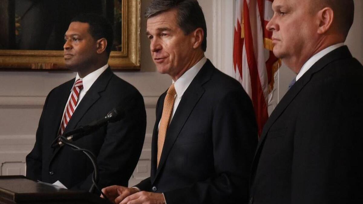 Gov. Roy Cooper (center) in January announced the selections of James Trogdon (right) as secretary of the Department of Transportation and Michael Regan (left) to lead the Department of Environmental Quality.