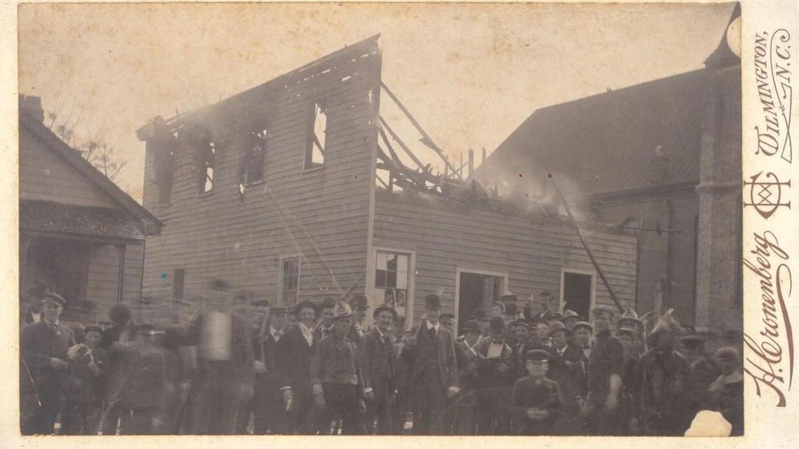 A photo from the Wilmington coup showing rioters in front of the burned-out Daily Record newspaper press owned by Alex Manly, a black writer, on Nov. 10, 1898.