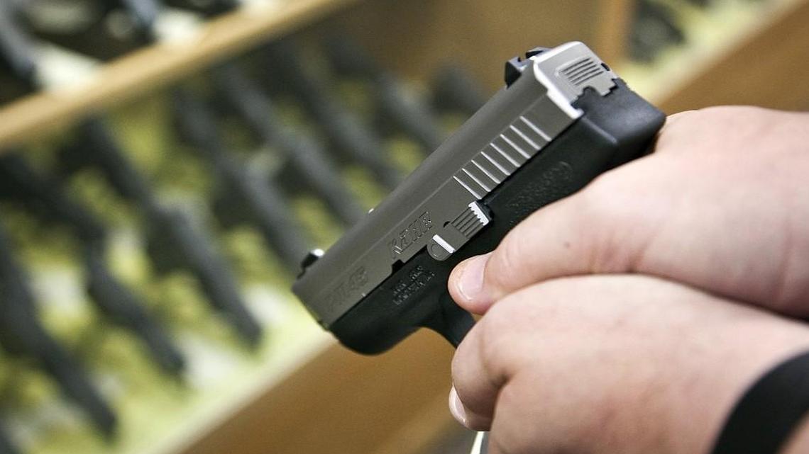 A customer checks out a conceal carry pistol at the Bullet Stop. (June 4, 2013)