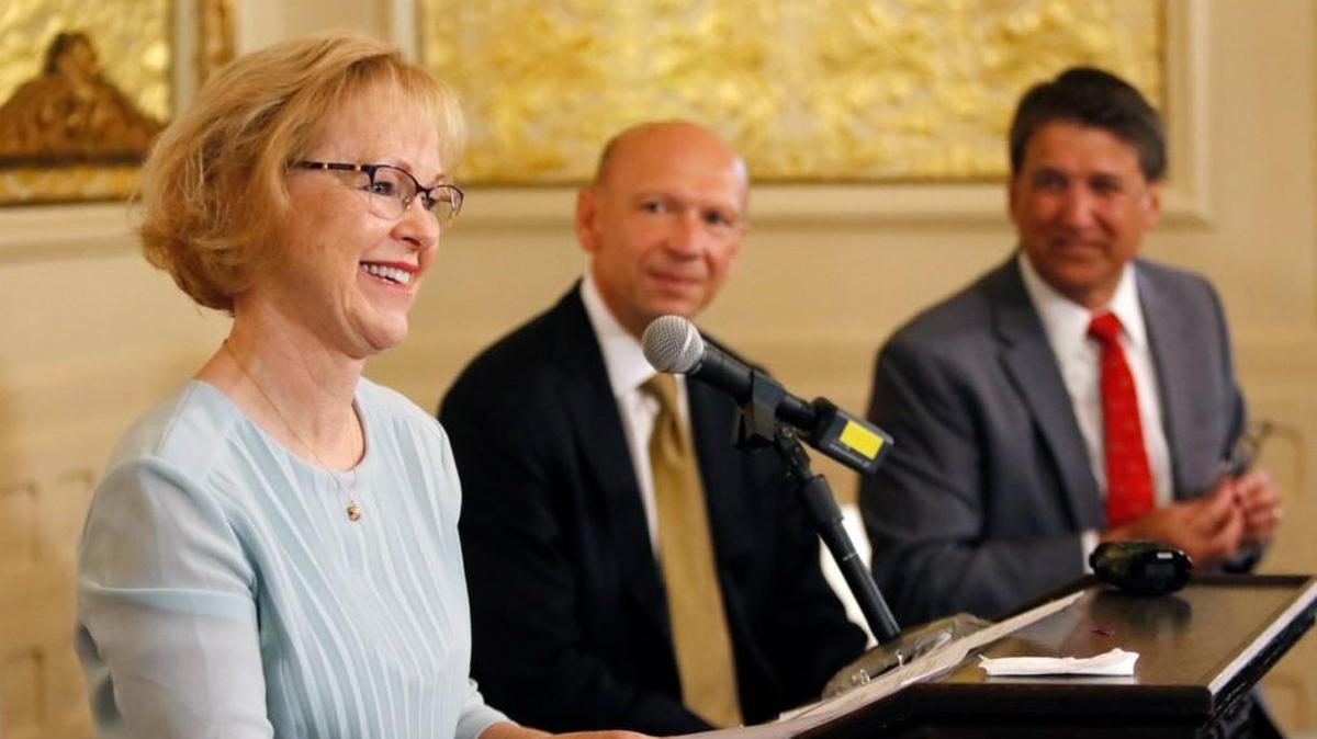 From left, outgoing NC DHHS Secretary Aldona Wos thanks her DHHS staffers in the audience for their hard work as Rick Brajer and NC Governor Pat McCrory listen during a press conference Aug. 5, 2015, at the Governor's Mansion in Raleigh, NC. Wos was the DHHS secretary in 2013 when the state fixed a problem of improper Medicaid payments. Now the federal government says the state owes it $41 million.