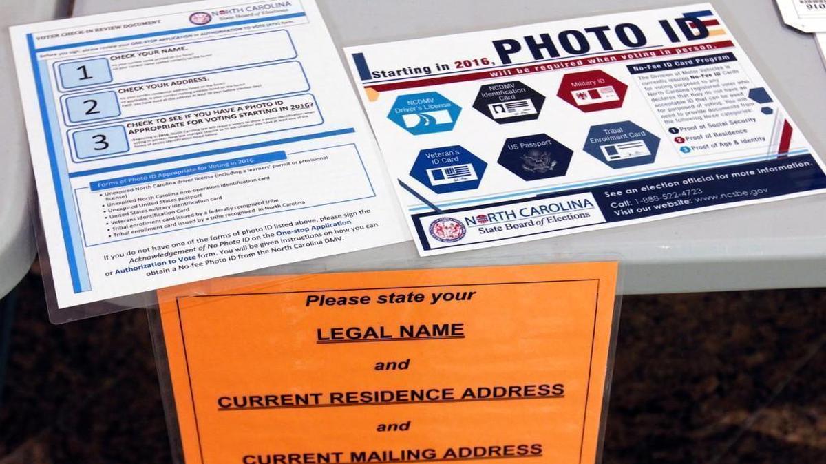 Information placards on the welcoming voters' table in the lobby of the Paul Green Theatre on the UNC-CH campus Tuesday morning, May 6, 2014 explain North Carolina’s new voter ID requirements.