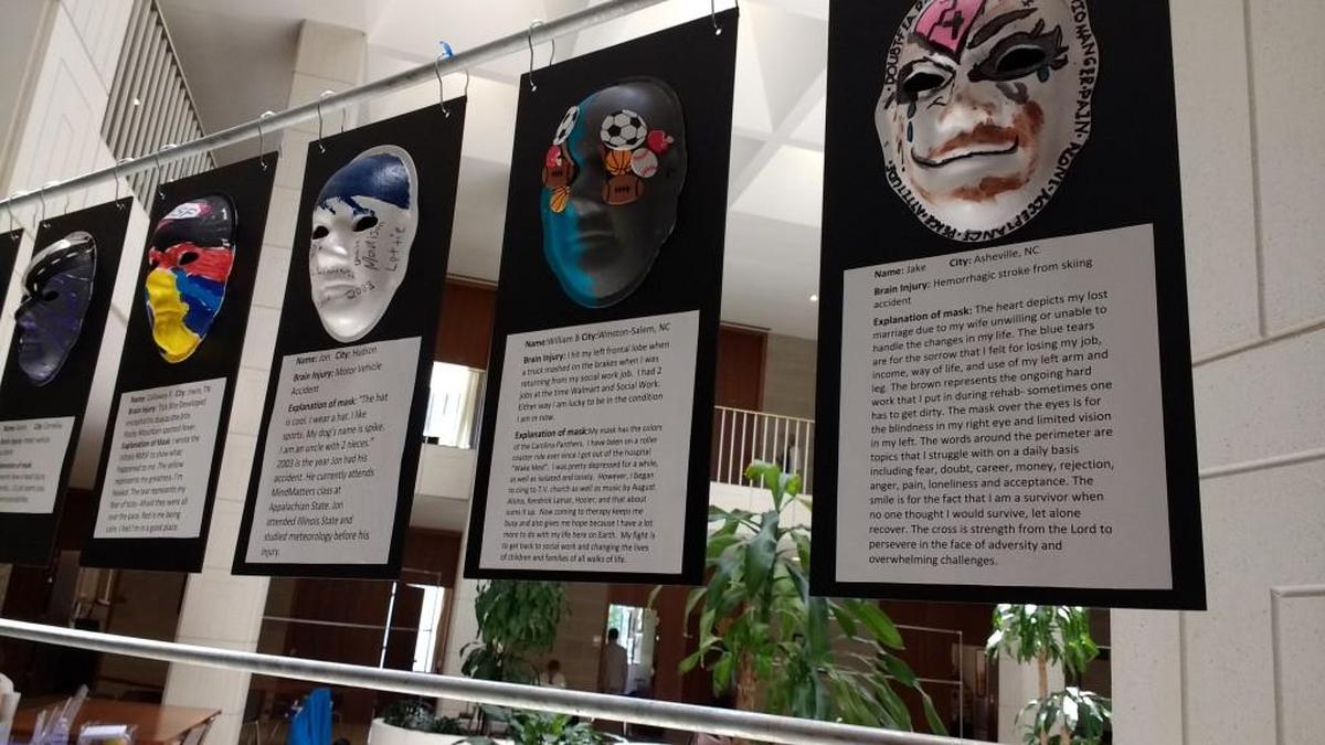 Brain injury survivors displayed masks they’d painted with their personal stories during an advocacy event for the Brain Injury Association of North Carolina.
