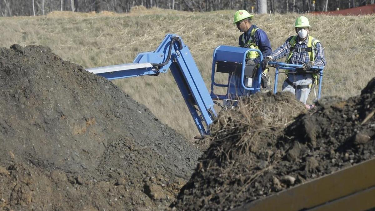 Workers excavate coal ash-laden soil from Duke Energy’s Dan River power plant in Eden.