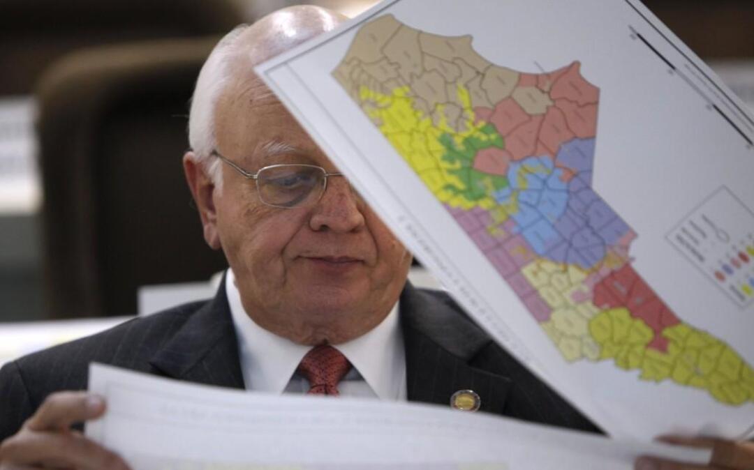 Rep. John Faircloth checks maps during a meeting of joint redistricting committees Monday, Nov. 7, 2011.