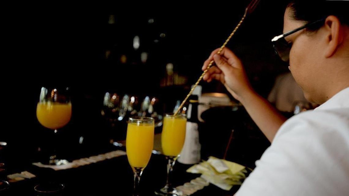 Mimosas are made at the bar as customers enjoy brunch at 5Church restaurant in Charlotte.