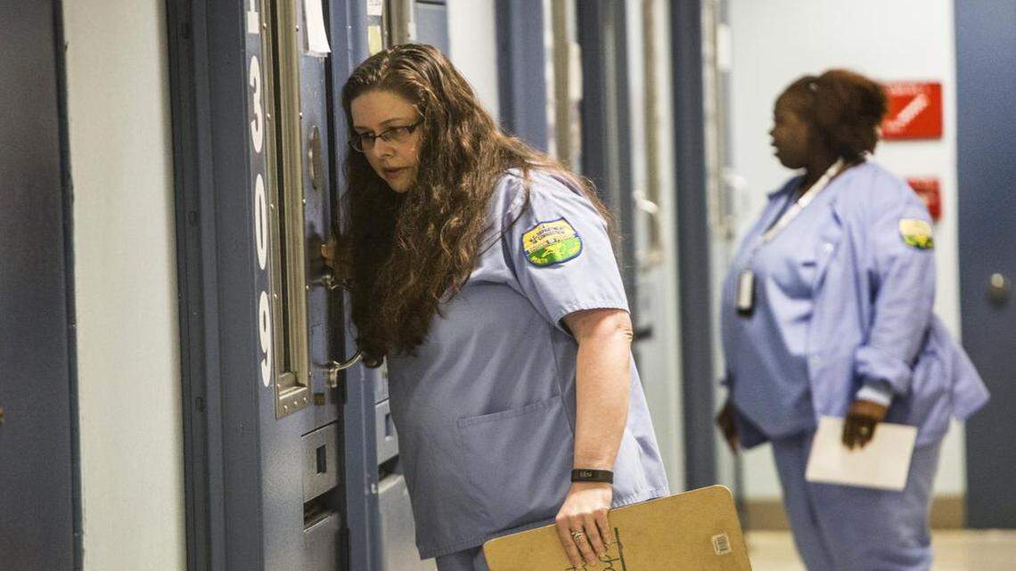 
Contract nurse Wendy Vaught, foreground, checks on a prisoner Thursday, April 16, 2015 at North Carolina Central Prison Regional Medical Center and Mental Health Facility. Agencies, like the Department of Public Safety, rely heavily on personal services contracts to hire medical staff because it's difficult to recruit staff healthcare workers in the prison system. 
