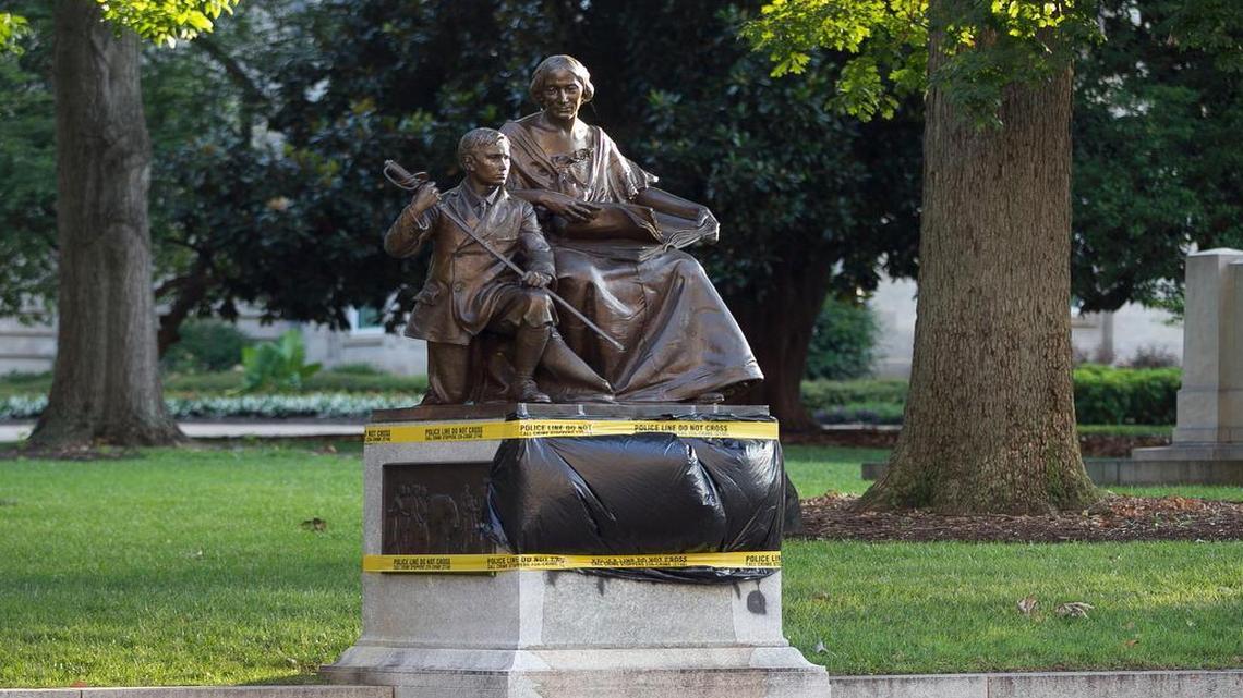 
Black plastic and police tape cover the vandalism to the Confederate Women’s Monument on the State Capital grounds on Tuesday morning July 21, 2015 in Raleigh. A block away, the N.C. House debated the fate of Confederate monuments – and who should have the power to take them down.
