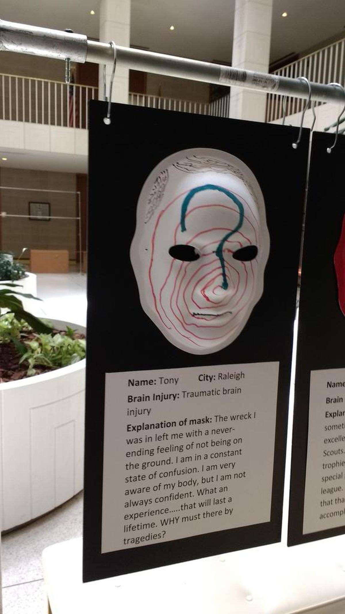 Brain injury survivors displayed masks they’d painted with their personal stories during an advocacy event for the Brain Injury Association of North Carolina.