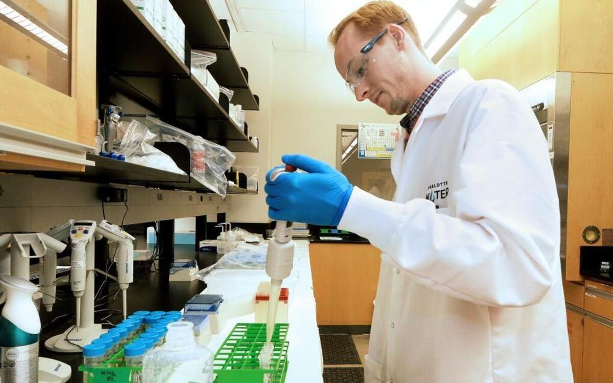 Cody Gibson pipettes water samples and transfers the samples to vials as he tests water in the lab at Charlotte Water's Environmental Services Facility on January 28, 2016.