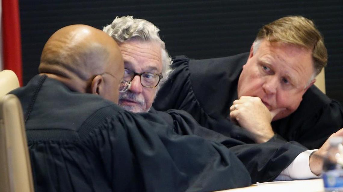 A three-judge panel of L. Todd Burke, left, Jesse Caldwell, center, and Jeffrey Foster confer as they hear arguments in the most recenbt lawsuit filed by Gov. Roy Cooper challenging the second rendition of the elections board-ethics commission revamp. The hearing is being held at Campbell Law school on June 1, 2017
