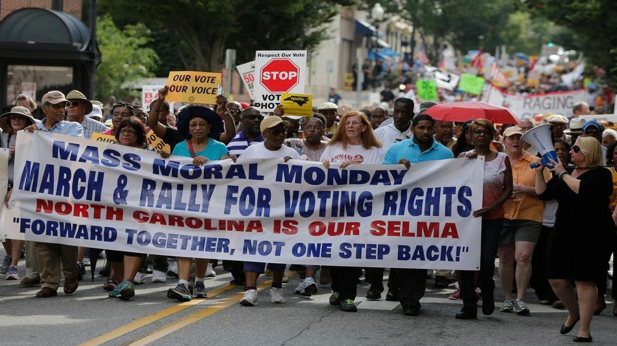 
Demonstrators march through the streets of Winston-Salem on July 13, 2015, after the beginning of a federal voting rights trial challenging a 2013 state law. 
