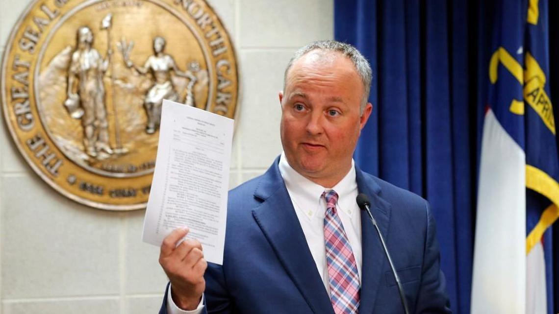 N.C. House Democratic leader Rep. Darren Jackson holds up a bill on March 28, 2017. On Jan. 30, Jackson formally asked for new protections at the N.C. General Assembly that he claims would help prevent sexual harassment.