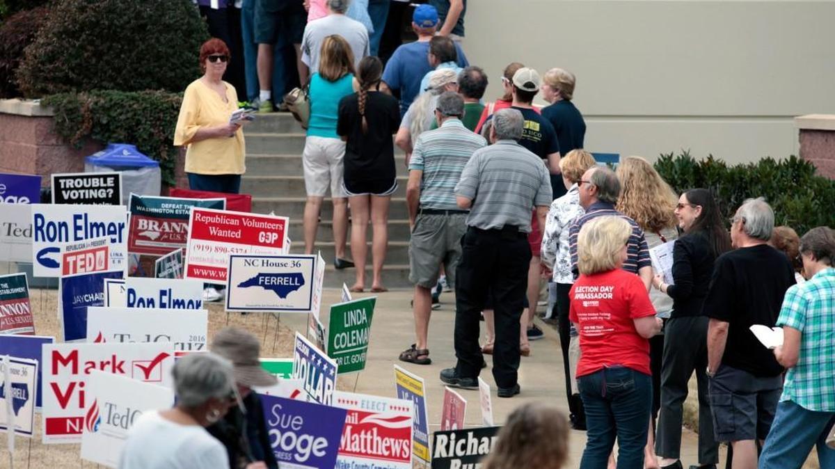 Wake County voters line up well out the front door at the Herbert C. Young Community Center early voting site during lunchtime in Cary, NC, Friday, March 11, 2016.