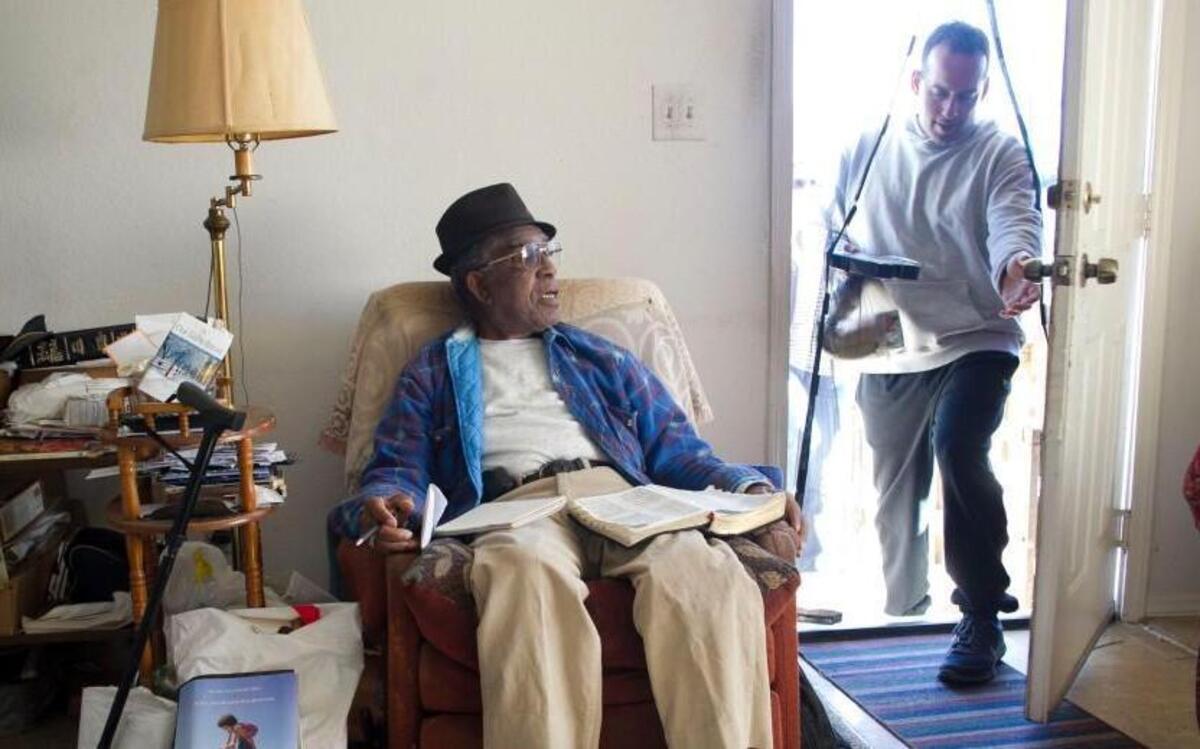 Meals on Wheels volunteer Michael Verdi of Apex, N.C. delivers a meal to Gene Hooker, age 87, at his home on Thursday in Raleigh, N.C. Verdi has been a volunteer for ten years, and has been delivering to Hooker for five years.