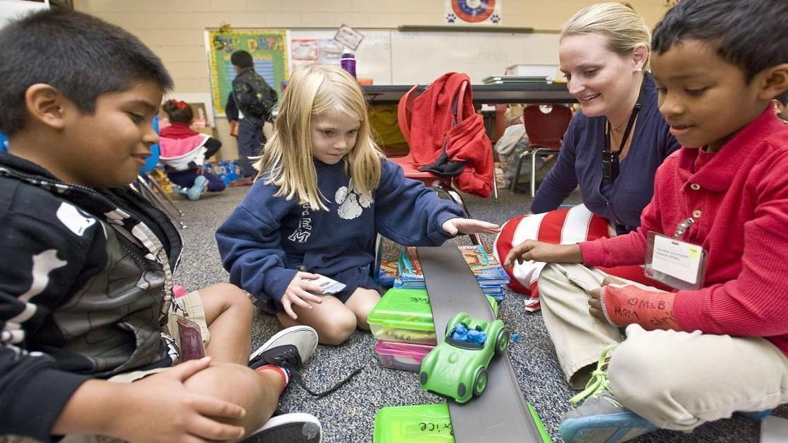 From left, Dylan Solano 6, watches as Elise Horn, 6, pushes the car, which is starting off the track, with Lindsey Plunkett and Aldo Salado standing by at Coltrane-Webb STEM Elementary School in 2015. Cabarrus County is among 20 counties that would be allowed to start school as early as Aug. 10 under a bill approved by the state House on Thursday, April 6, 2017.