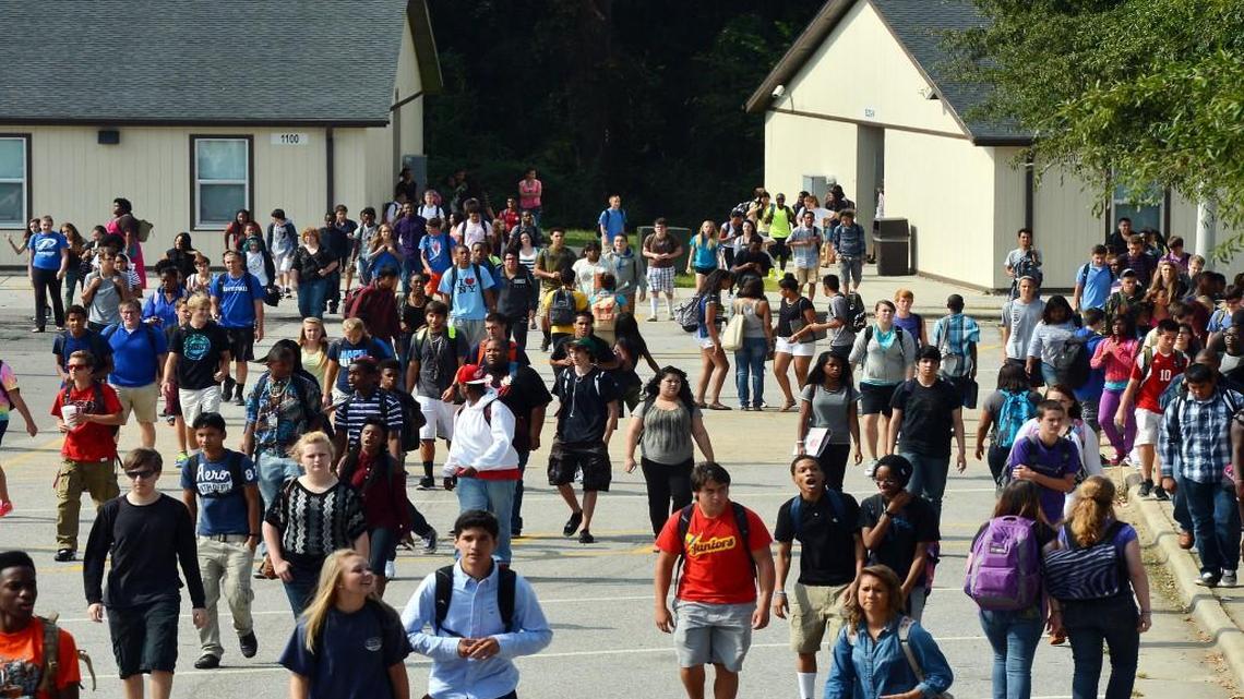 Students at Garner High School walk from modular classroom structures as they change classes on Aug. 28, 2013.