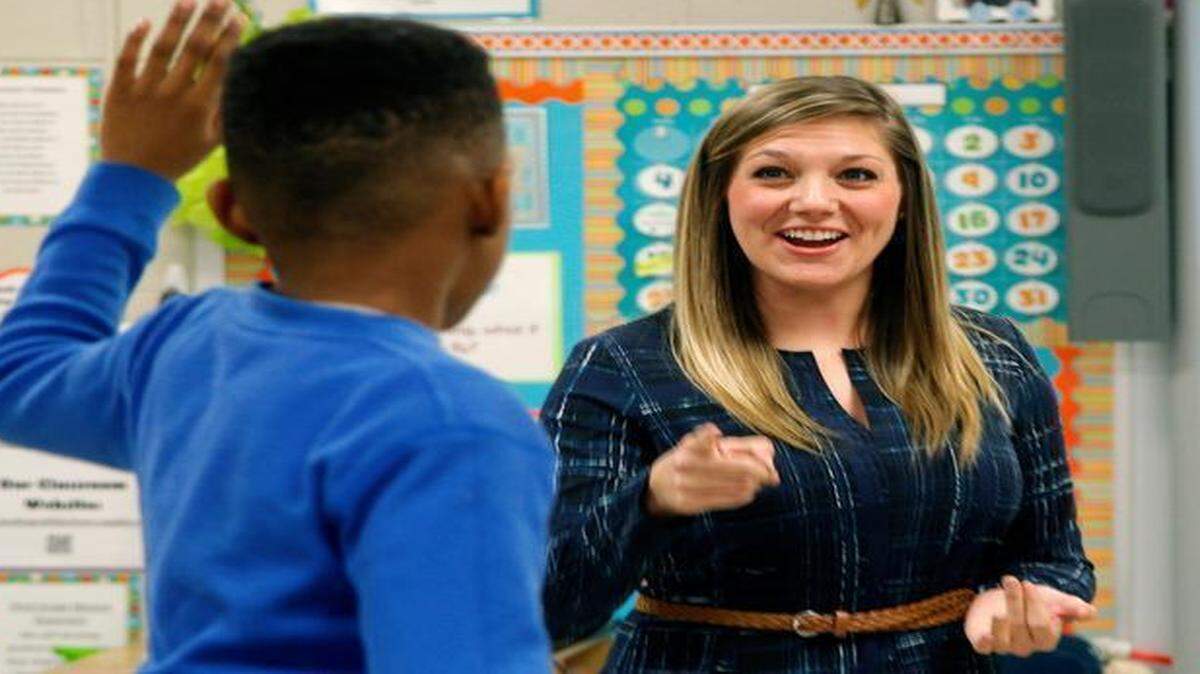 
Teacher Emily Levinson, right, has student Jacobi Walters stand on his chair to be recognized after he got high marks on a computer quiz in her third-grade class at A.B. Combs Elementary School in Raleigh. Gov. Pat McCrory’s budget plan keeps a pledge he made to increase teacher pay, including raising the minimum teacher salary to $35,000 a year.
