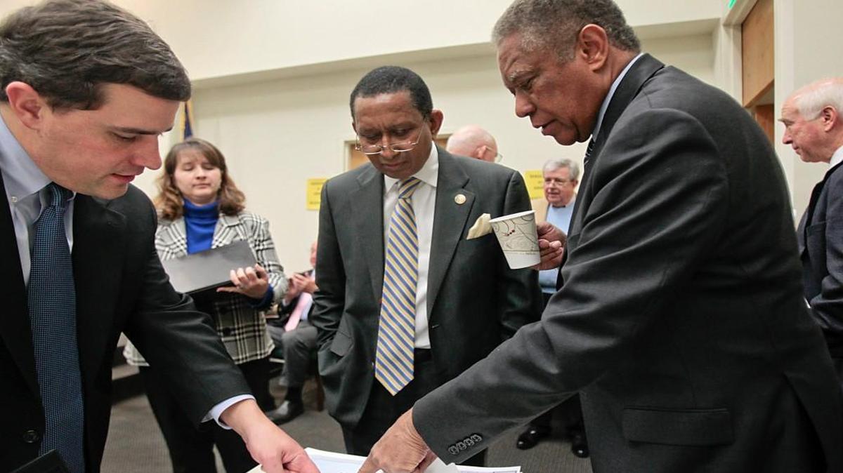 Jim Blaine, chief of staff for Senate Leader Phil Berger, left, reviews a districting map used from 1983-1992, before the 12th District was formed with Democratic Senators Senator Floyd McKissick, Jr., center, and Dan Blue, right, during a break in the Joint Select Committee on Congressional Redistricting meeting at the N.C. Legislature on Tuesday, February 16, 2016.