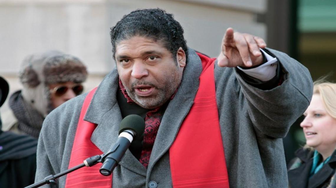 Rev. William Barber urges HKonJ march protesters to both donate to the cause and get in their march groups at the end of the rally portion in front of Memorial Auditorium in downtown Raleigh, NC Saturday morning, February 13, 2016. Rev. Barber was one of the many speakers for the 10th annual Historic Thousands on Jones Street protest march. An estimated five thousand marchers braving the below freezing temps and wind chill.