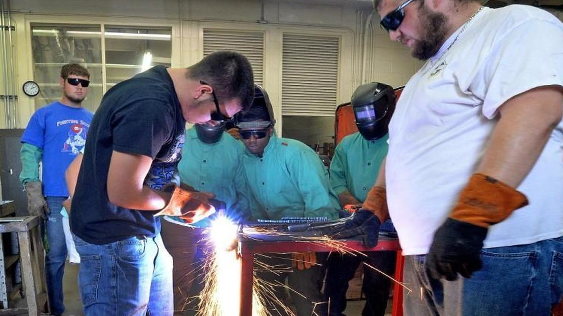 Josh Outlaw (left) uses a plasma torch to cut a piece of steel as fellow students look on during the metal working class at Scotland County High School in Laurenburg, N.C. Friday, September 23, 2016. At right is Mick Davis who will grab the hot metal before it hits the floor. The high school has a vocational program second to none to help students get real life skills that can provide work as soon as they graduate.