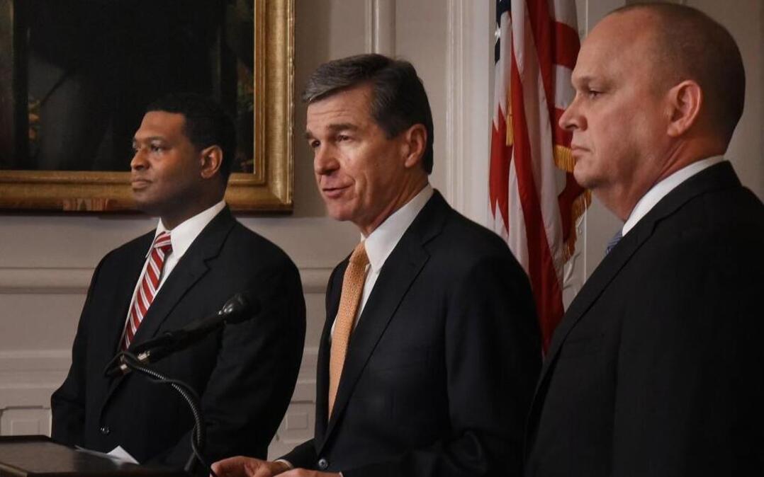 Gov. Roy Cooper, center, with Transportation Secretary Jim Trogdon, right.