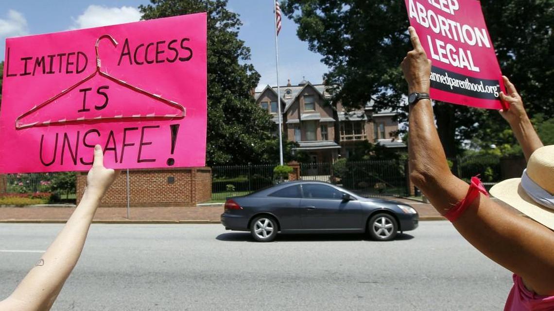 Planned Parenthood supporters try to get passing motorists to honk for their cause as they participate in a two-day vigil in front of the governor's mansion in Raleigh in 2013.