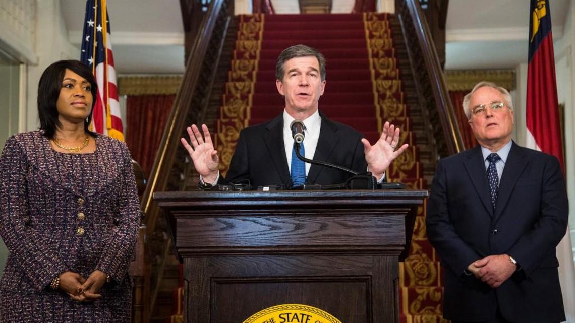 Gov. Roy Cooper, center, announces the selection Machelle Sanders, left, to lead the Department of Administration and Tony Copeland to lead the Department of Commerce Thursday, January 12, 2017 during a press conference at the Executive Mansion.