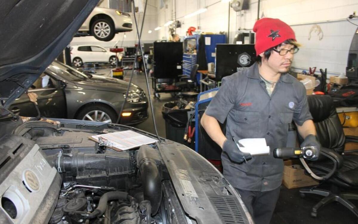 
Auto mechanic Deven Lee works on cars at Leith Volkswagen in Cary. The legislature’s budget bill would add sales tax to labor charges at automotive shops.
