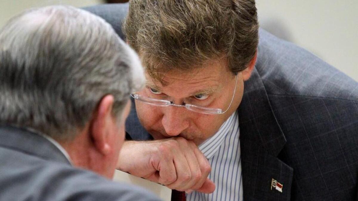 
Rep. Nelson Dollar (R-Wake), right, senior chair of the House Appropriations committee, confers with Rep. Jimmy Dixon (R-Duplin, Wayne) at the conclusion of a committee meeting at the Legislative Office Building in Raleigh on Wednesday, July 29, 2015. The N.C. House and N.C. Senate have yet to reach a budget agreement for the 2015 session. 
