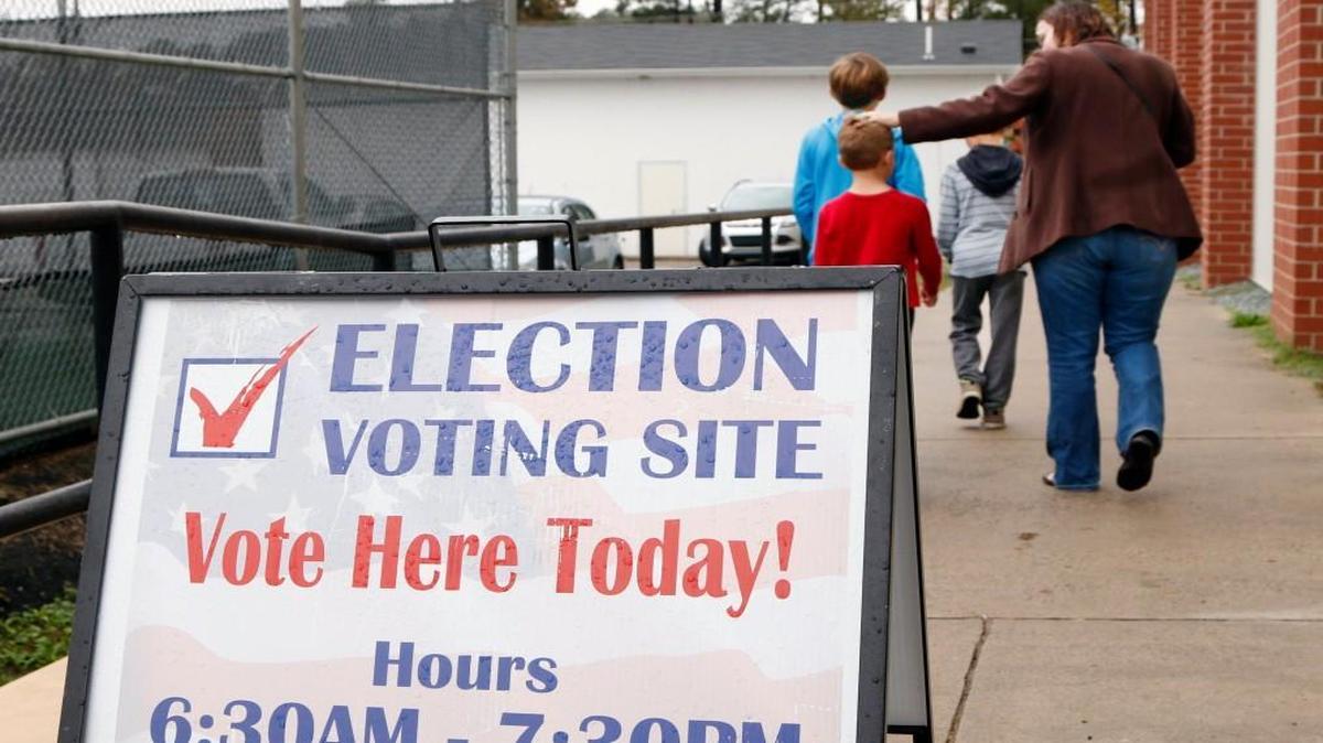 A mom and her three kids leave the Chapel Hill High School/North Carrboro precinct polling place after she voted Tuesday, November 3, 2015. Five towns in North Carolina will hold the 2015 municipal elections again because election law violations might have tainted the original outcome.