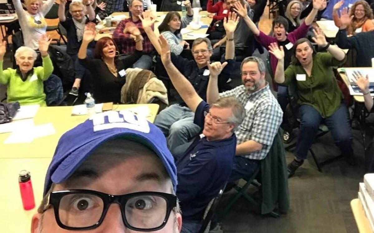 Brian Fitzsimmons of the Wake County Democratic Party takes a selfie with Democrats who attended a recent precinct meeting in Apex.