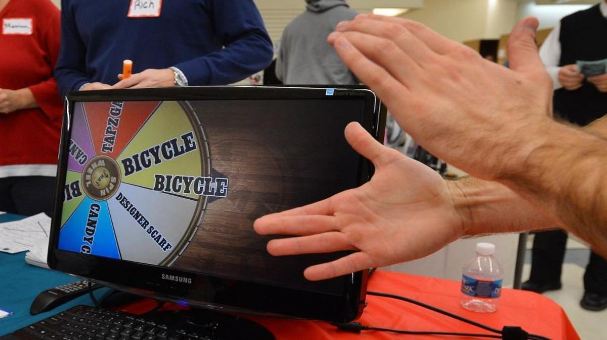 The computer generated raffle wheel stops on "BICYCLE" and another lucky family wins a Christmas bike from the Triangle Spokes Group and the Salvation Army Wednesday Dec. 18, 2013 in Raleigh, N.C. A House bill would allow charity raffles and other games of chance at restaurants that serve alcohol.