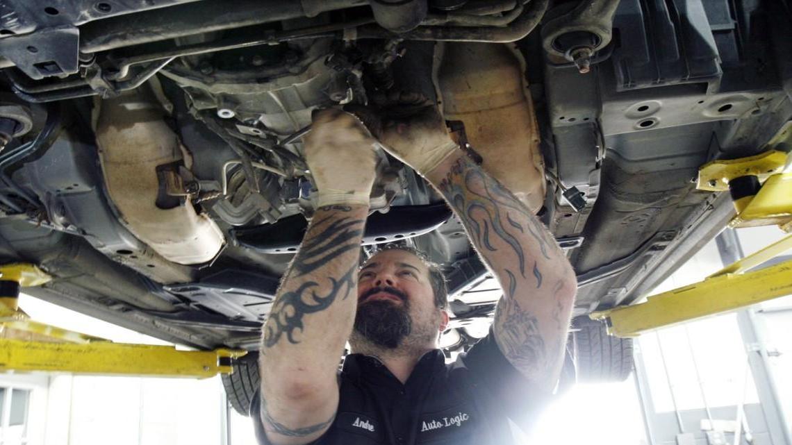 Tech mechanic Andre Dalrymple does transmission inspection and repairs to a customer's car at Auto Logic of Carrboro in 2013. Car repairs will be subject to sales taxes starting on Tuesday.