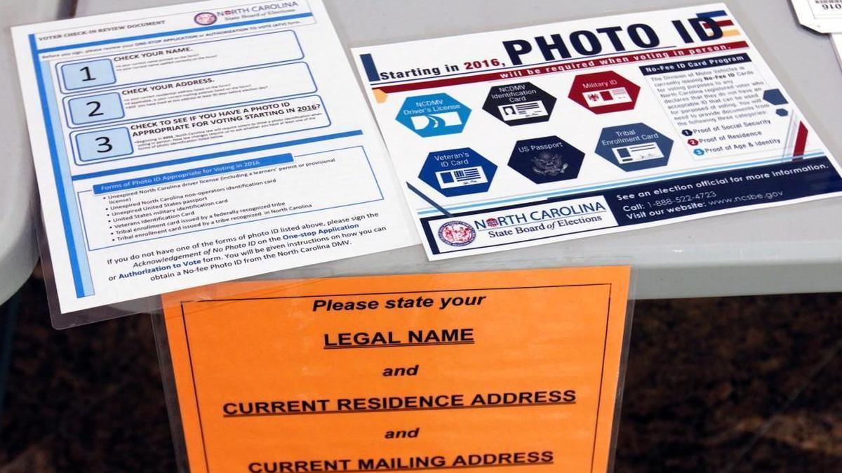 Information placards are displayed on a table in the lobby of the Paul Green Theatre on the UNC-CH campus Tuesday morning, May 6, 2014. Voters will need to have a valid photo ID to vote beginning in 2016.
