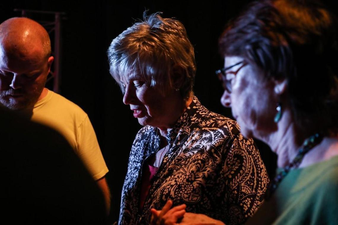 Debbie Moss, center, leads her church's band in prayer before service on Sunday Nov. 12, 2017.