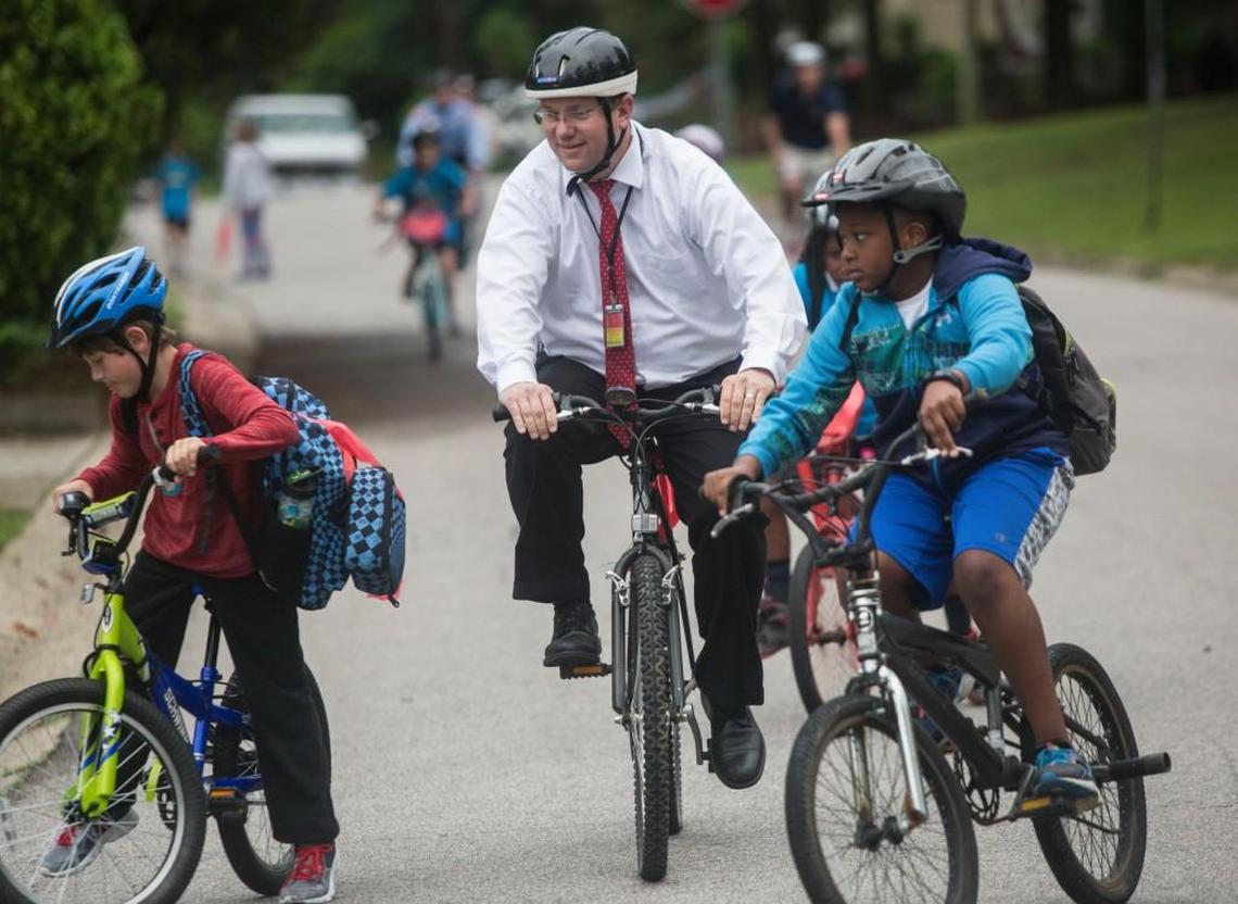 Powell GT Magnet Elementary School principal Curtis Brower pedals with students to Powell Elementary School in Raleigh Wednesday, May 4, 2016.