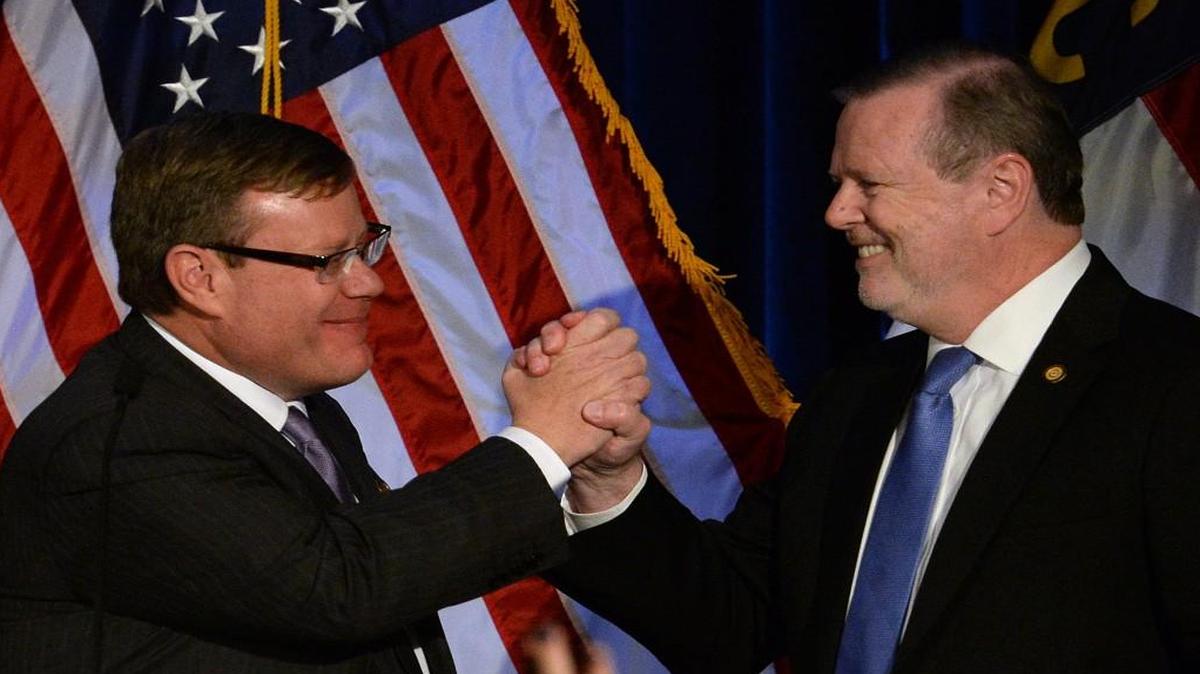 House Speaker Tim Moore, left, and Senate leader Phil Berger argue that Republican fiscal policies have resulted in a budget surplus.